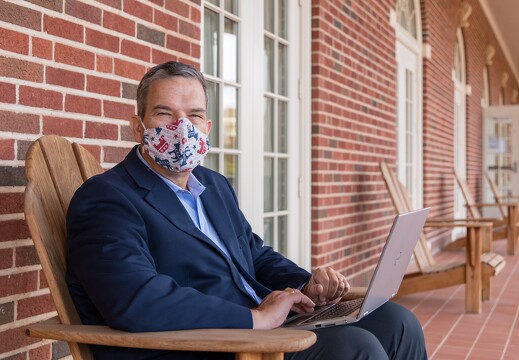 Dean Glen Krutz masked with laptop